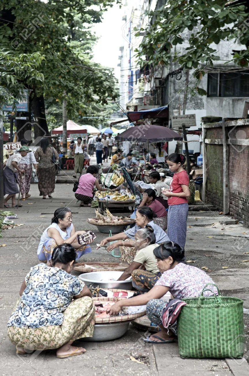 Row of street food stalls with fried snacks and vendors
