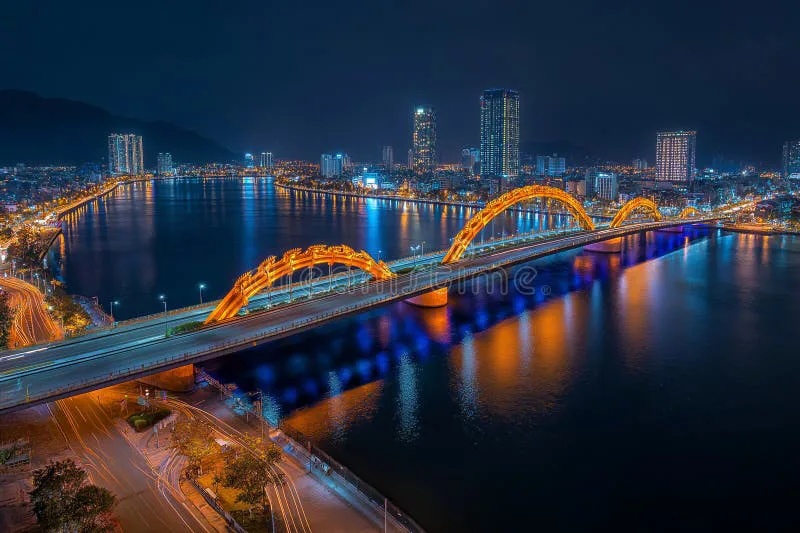 Da Nang skyline at night with illuminated bridges reflecting on the Han River