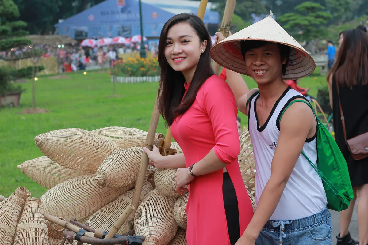 People dressed in red and yellow áo dài celebrating Tet