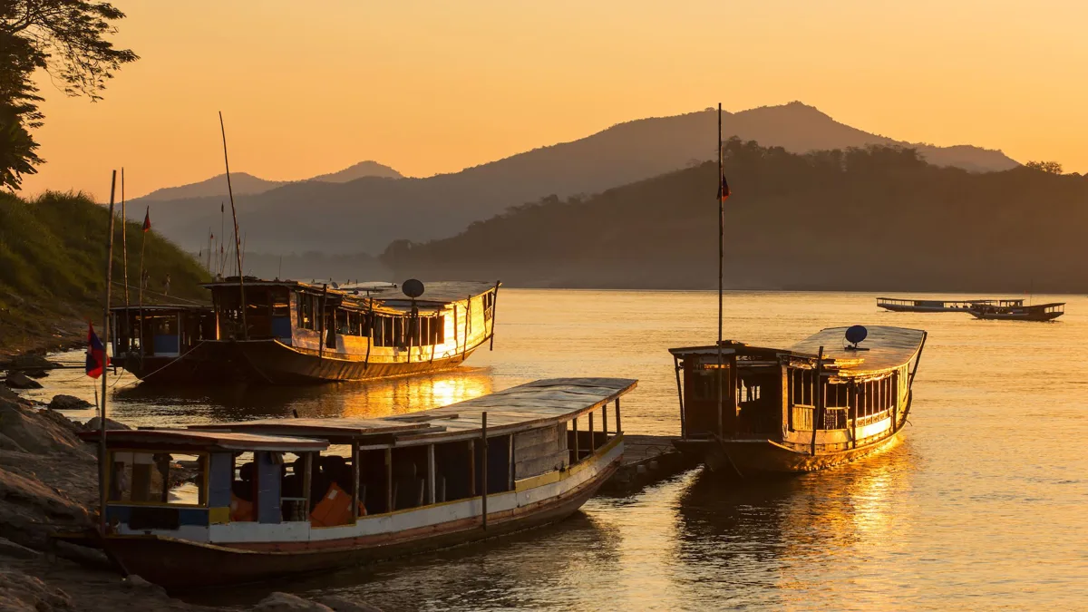 Long view of the Mekong River flowing past Luang Prabang at sunset