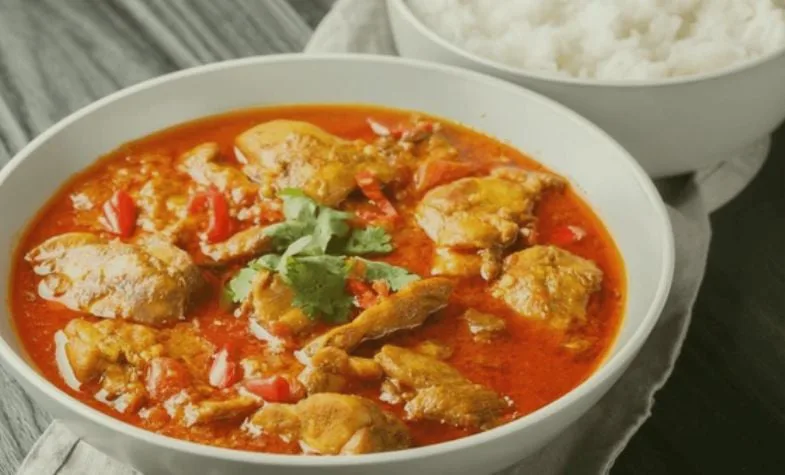 Burmese curry served with multiple small side dishes and dips