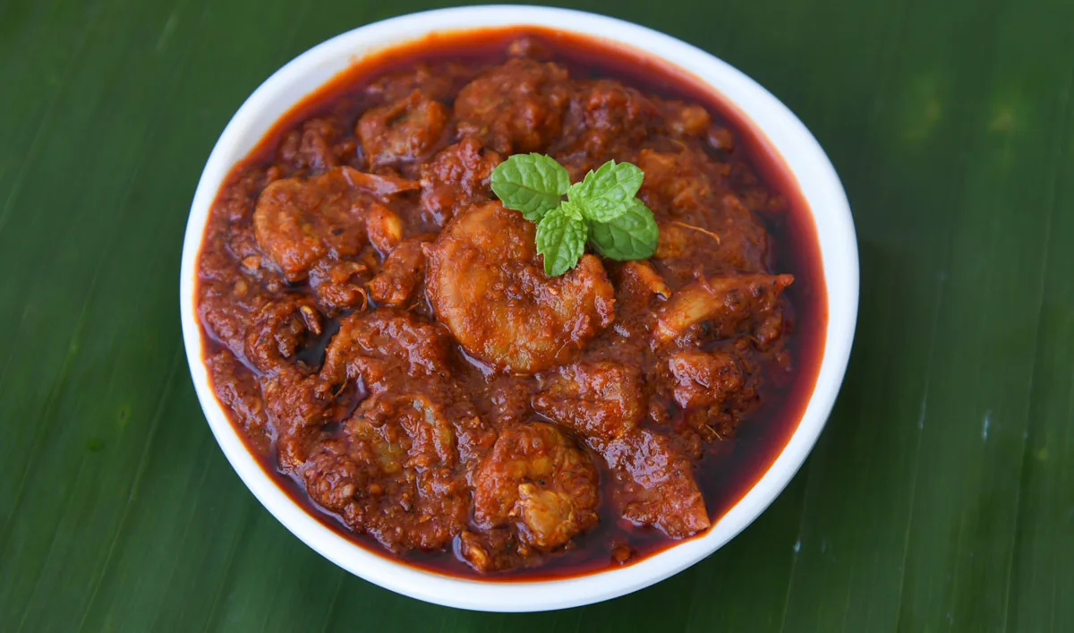 Burmese curry served with multiple small side dishes and dips