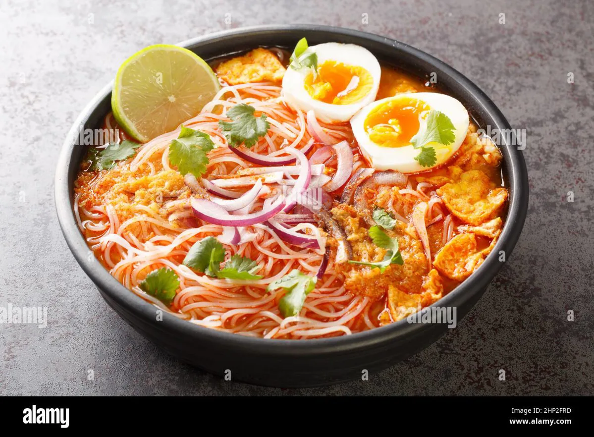 Bowl of mohinga with rice noodles and garnishes