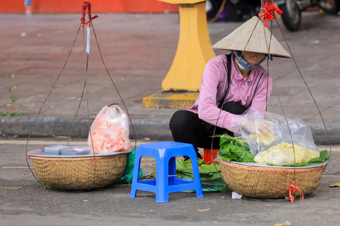 Hot bowl of pho being served by a street vendor