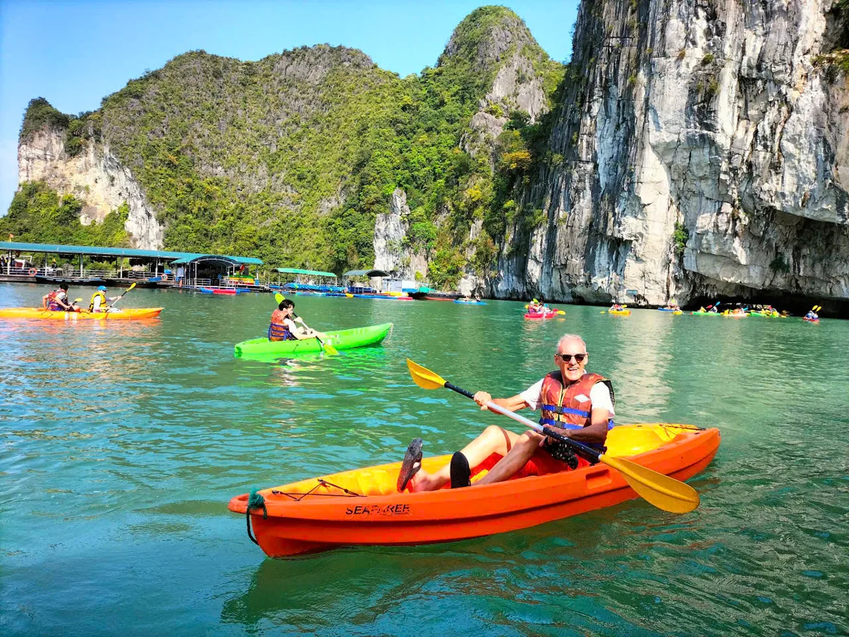 Limestone karsts rising from calm emerald waters of Halong Bay