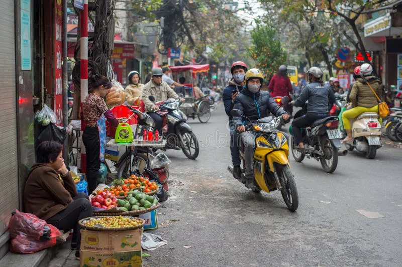 Crowded Vietnamese street filled with motorbikes at sunset