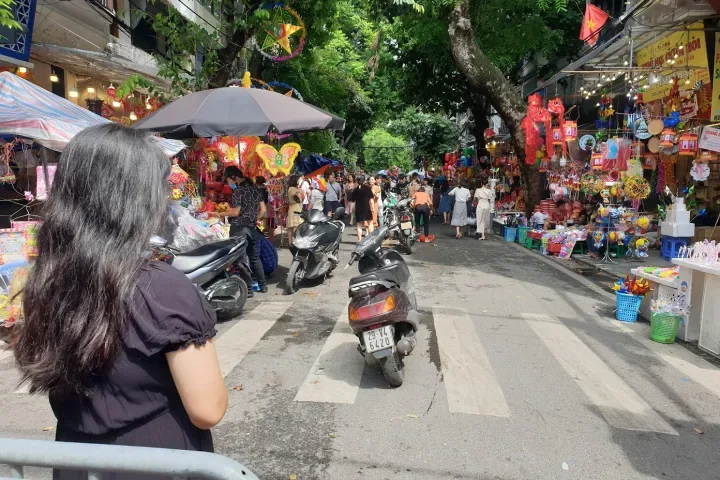 Busy street in Hanoi's Old Quarter with colonial-era buildings