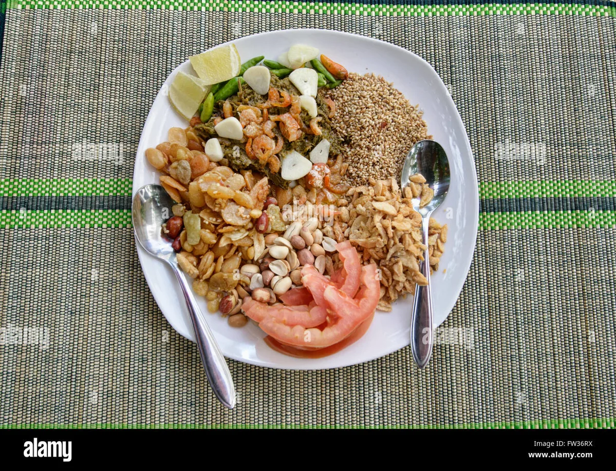 Assorted Burmese dishes including mohinga, lephet thoke and curry on a table