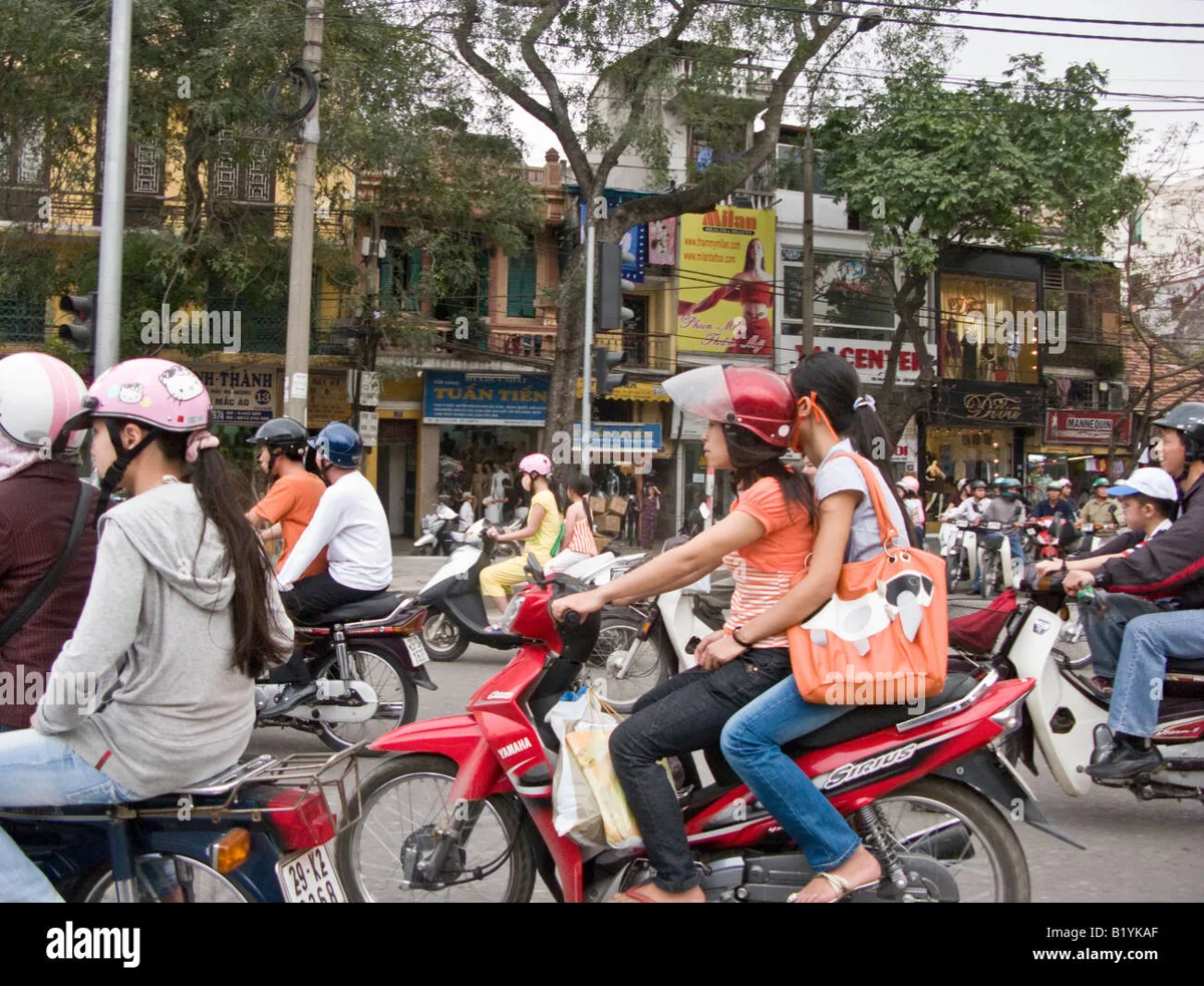 Crowded Vietnamese street filled with motorbikes at sunset