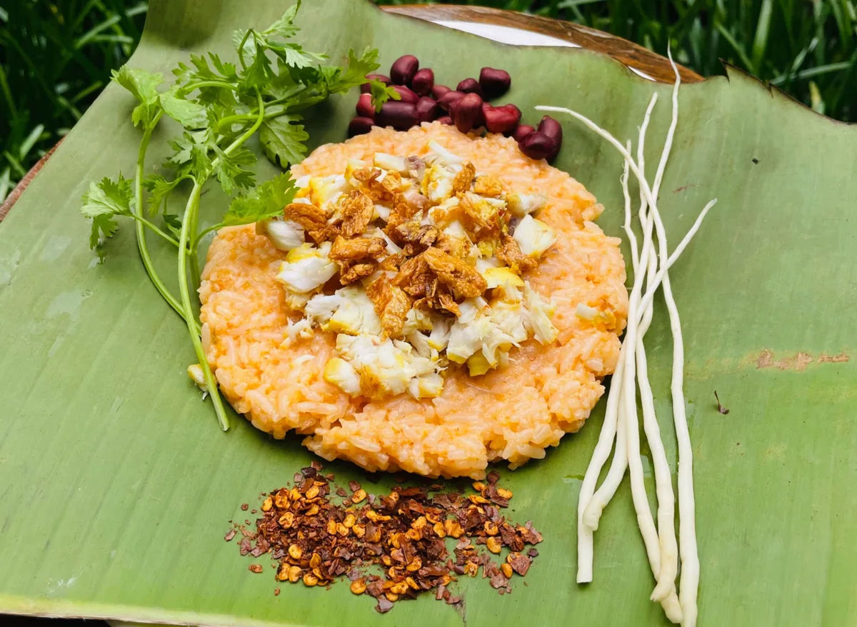 Turmeric rice topped with flaked fish and garlic oil