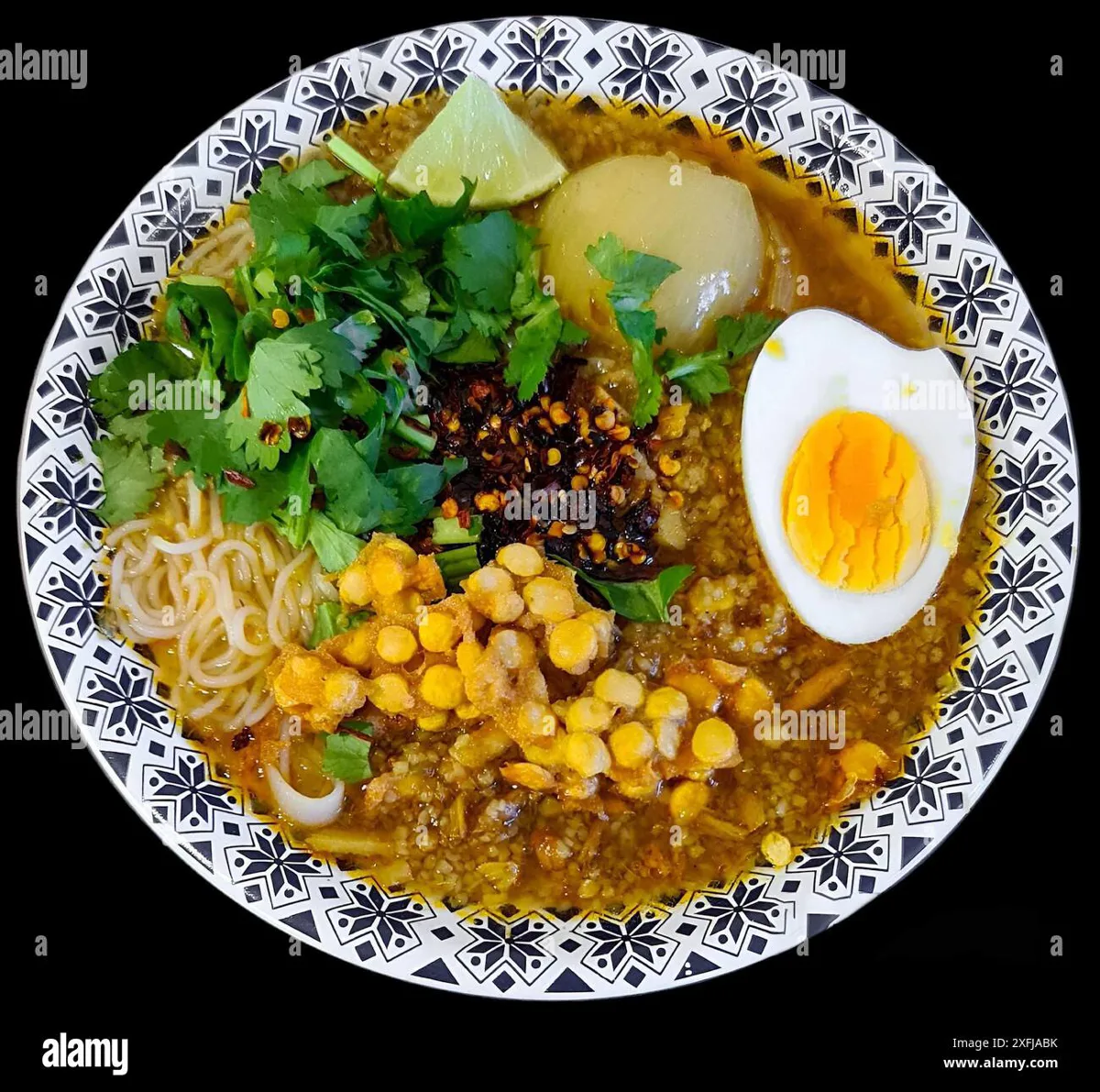 Bowl of mohinga with rice noodles and garnishes