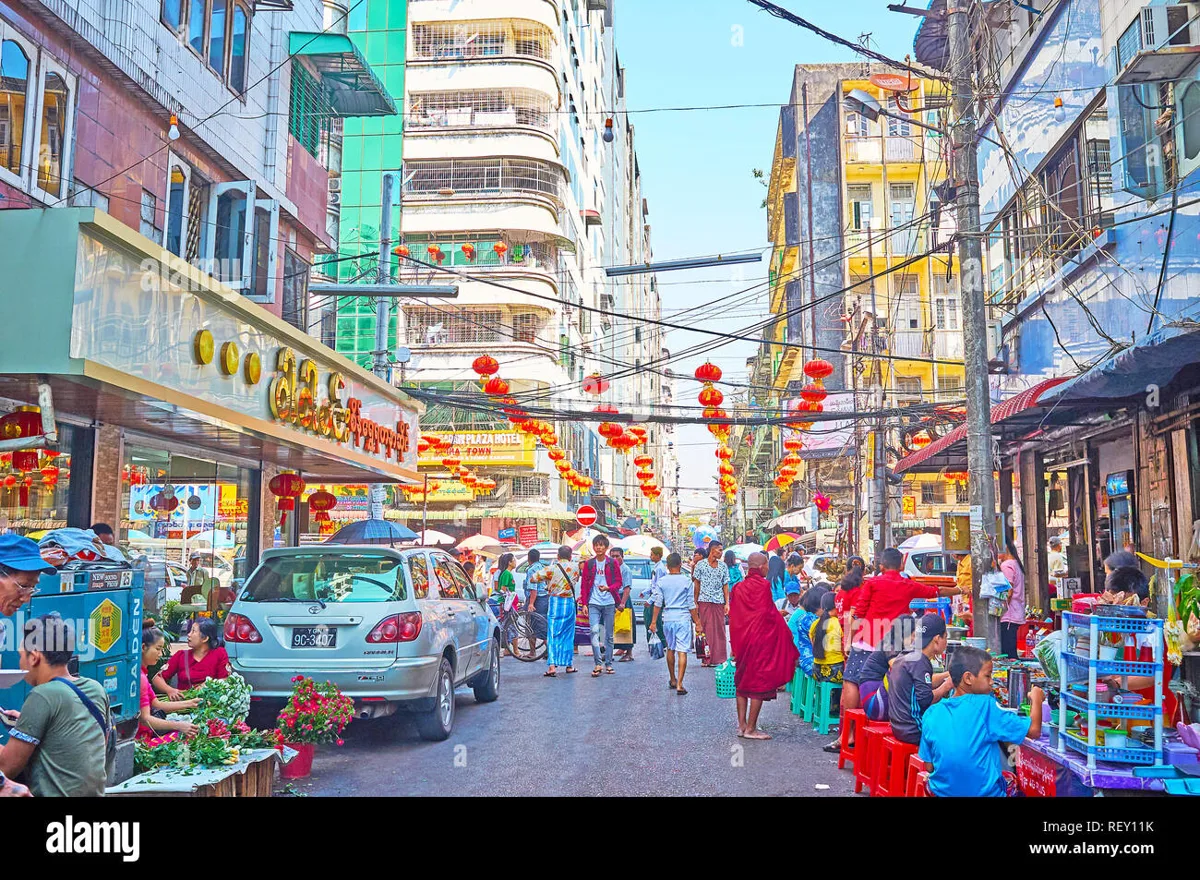Row of street food stalls with fried snacks and vendors