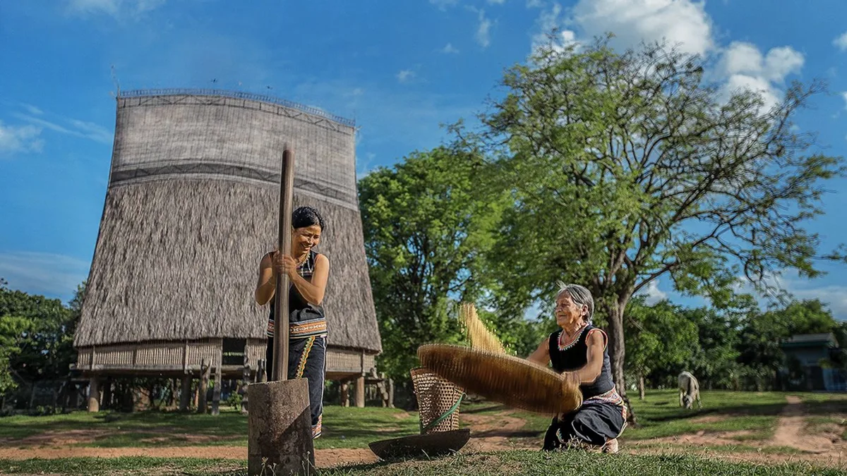 Historic Wooden Church of Kon Tum with traditional communal house in the background, showcasing the city's unique cultural bl
