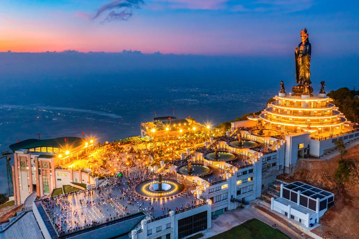 Panoramic view of Tay Ninh city and the Cao Dai Holy See from Ba Den Mountain, featuring lush landscapes and unique architect