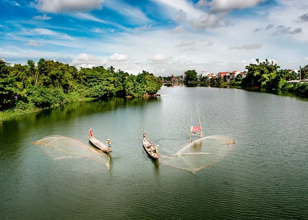 Traditional dragon boat on the Perfume River at sunset in Hue, Vietnam