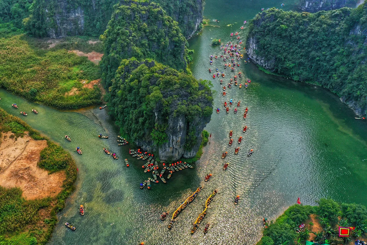 Traditional boat trip through limestone karsts in Tam Coc, Ninh Binh, Vietnam
